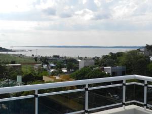 a view of the water from the balcony of a building at El Departamento de los Abuelos in Posadas