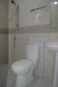 a bathroom with a toilet and a sink at Red Apartelle in Talisay