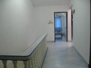 a hallway with a bench in a room with a door at Yong Homestay in Kuala Perlis
