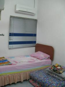 Katil atau katil-katil dalam bilik di Yong Homestay