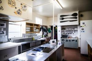 a large kitchen with stainless steel counters and appliances at The Pickled Frog in Hobart