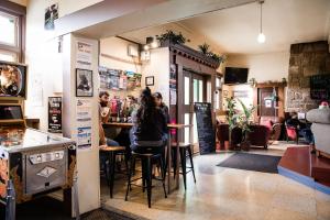 a woman sitting at a bar in a restaurant at The Pickled Frog in Hobart