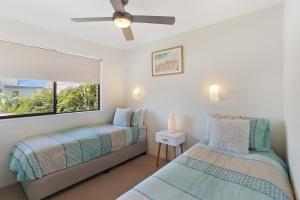 A bed or beds in a room at Low Tide on Noosa Sound - Pet Friendly