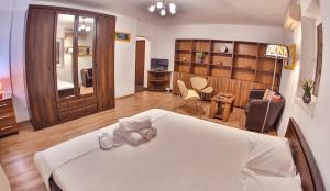 a bedroom with a bed and a living room at Dream Residence splai in Bucharest