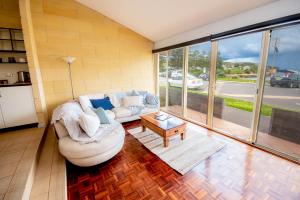 a living room with a couch and a table at Bayview no 2 in Port Campbell