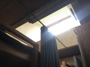 a window in a room with a curtain at Guest House Minato in Miyako
