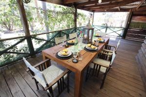 a wooden table and chairs on a deck at Silverpoint Estate in Pokolbin