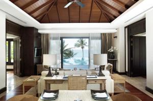 a living room with a couch and a table at Trisara - SHA Plus in Nai Thon Beach