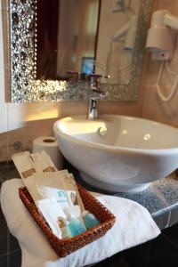 a bathroom with a sink and a white sink at Manorom Boutique Hotel in Vientiane