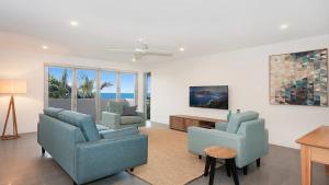 a living room with two chairs and a table at Vista in Lennox Head