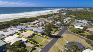 an aerial view of a suburb with houses and the beach at Bailey's Beach House in East Ballina