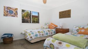 a bedroom with two beds and a window at Betty's in Lennox Head