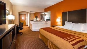a hotel room with a bed and a bathroom at Best Western Plus North Houston Inn & Suites in Houston