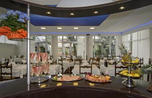 a dining room with a table with plates of food at Hotel Roma in Marina di Massa