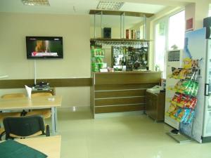 a room with a store with a cash register and a counter at Anelia Family Hotel in Kavarna