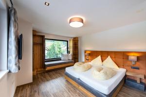 a bedroom with a bed with two pillows on it at Biwak Appartements in Sankt Anton am Arlberg