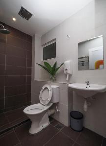 a bathroom with a toilet and a sink at S Boutique Hotel in Ipoh