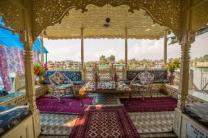 a gazebo with chairs and a table on a boat at Swan Group of Houseboats, Golden Dal Lake in Srinagar