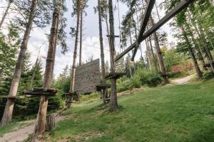 a wooden sign in the middle of a forest at Eco Hotel Zdravetz in Tsar Kaloyan