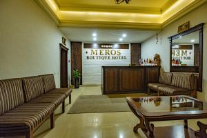 a lobby with couches and a table and a bar at Meros Boutique Hotel in Samarkand
