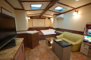 a room with a room with a bed and a television at Koriyama Aine Adult Only in Koriyama