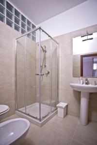 a bathroom with a glass shower and a sink at La Maison di Brigitte e Simone in Bentivoglio
