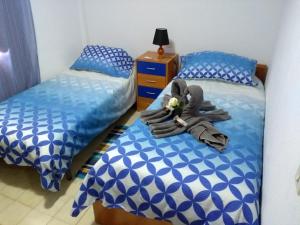 Postel nebo postele na pokoji v ubytování Arrecife Azul