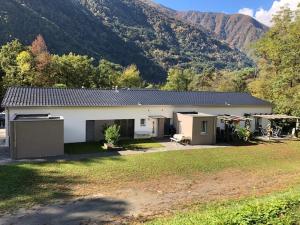 a white house with a mountain in the background at Villa Parasana in Gordevio
