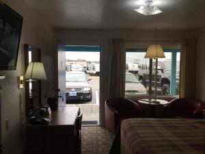 a hotel room with a bed and a view of a parking lot at Southsider Motel in Coos Bay
