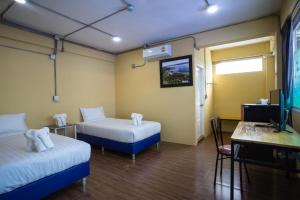 En eller flere senger på et rom på Baan Chang Hotel & Coffee House
