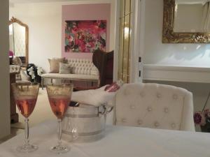 two glasses of champagne on a table in a living room at Boutiquehotel Villa Sissi in Salzburg