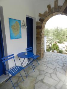 a blue table and chairs sitting on a patio at Aggelos Studios in Agios Prokopios