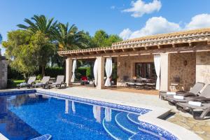 a villa with a swimming pool and a patio at Son March in Sa Pobla