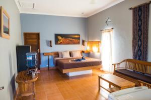 a bedroom with a bed and a camera in a room at Mandalika Cottage in Gili Trawangan