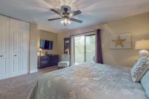 a bedroom with a bed and a ceiling fan at Gulf Winds #39 in Destin