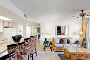a living room with a couch and a table at Sunrise Suites Paradise Escape #407 in Key West