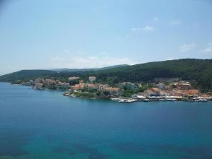 a large body of water with a town and houses at Nicolas Rooms in Fiskardo