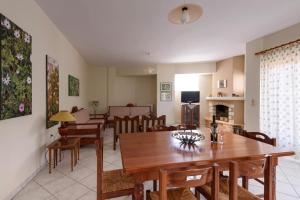 a dining room and living room with a table and chairs at Niki's Apartment in Palaiochora