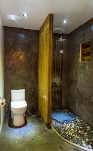 a bathroom with a toilet and a shower at Focus Rooms in El Nido