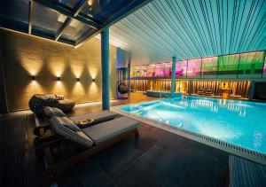 a swimming pool with a chaise lounge next to it at Maestral Resort & Casino in Sveti Stefan