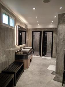 a large bathroom with a sink and a mirror at Al Sultan Beach Resort in Al Khor