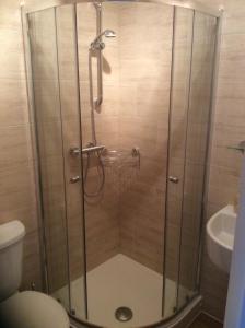 a shower with a glass door in a bathroom at Mill Croft Bed and Breakfast in Goathland