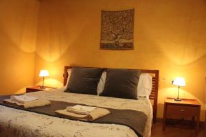 a bedroom with a bed with two towels on it at Appartamento Ernesto in Pistoia