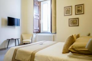 A bed or beds in a room at Palazzo Toledano