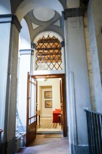 a hallway with an open door with a red couch at Palazzo Toledano in Naples