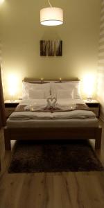 a bedroom with a bed with lights on it at Ditta Panzio in Debrecen