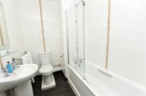 a bathroom with a toilet and a sink and a bath tub at Green Lodge, Wirral by Marston's Inns in Hoylake