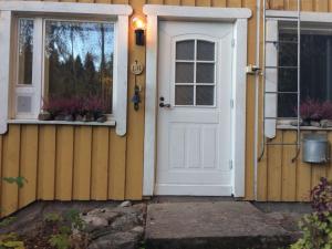 a white door and windows on a house at House with private beach in Rautalampi