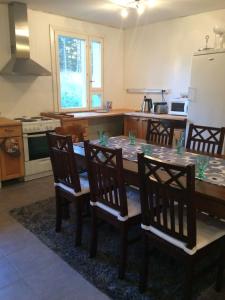 a kitchen with a dining room table with four chairs at House with private beach in Rautalampi