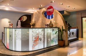 a lobby with a counter in the middle of a building at Astir Notos in Potos +37 photos